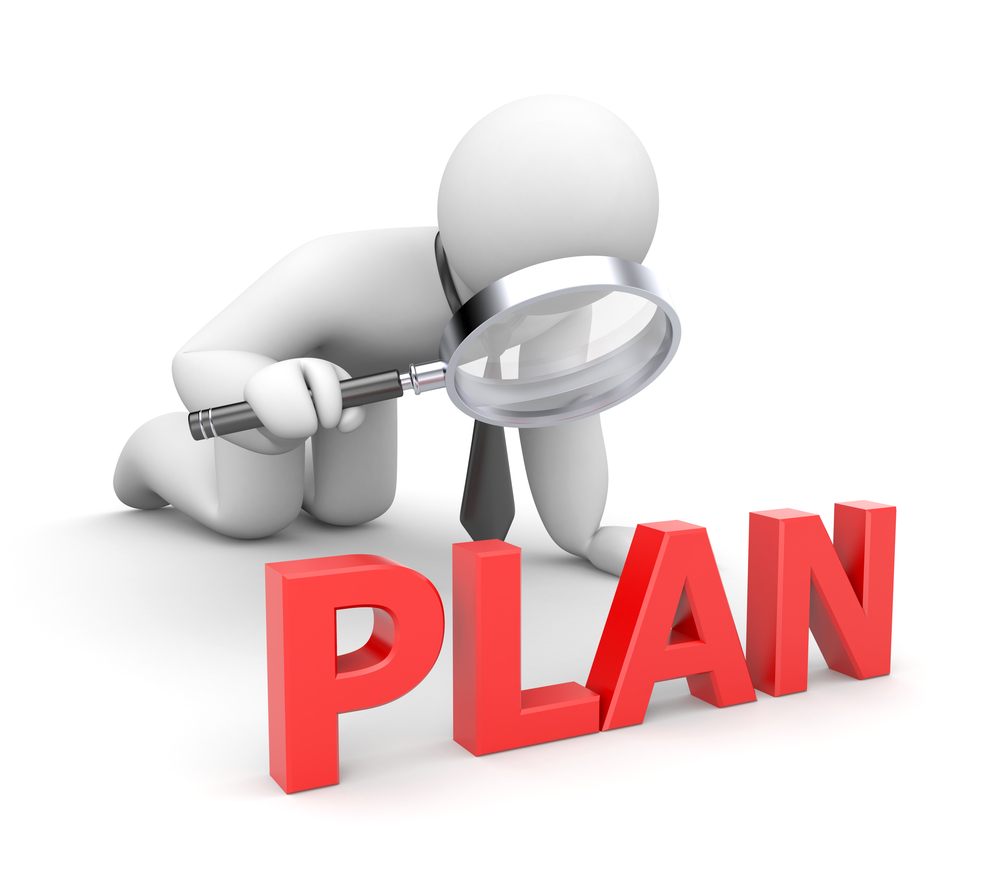 White 3D figure with a black necktie examines the word "Plan" in large,  red, 3D block letters with a magnifying glass. Keyword: strategic planning